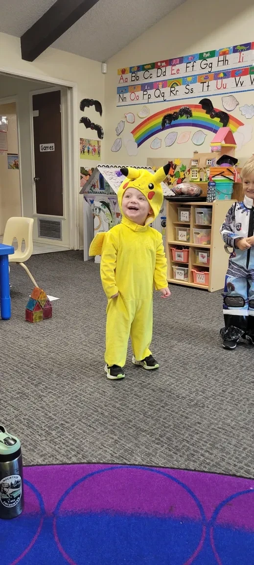 Child in Pikachu costume in classroom