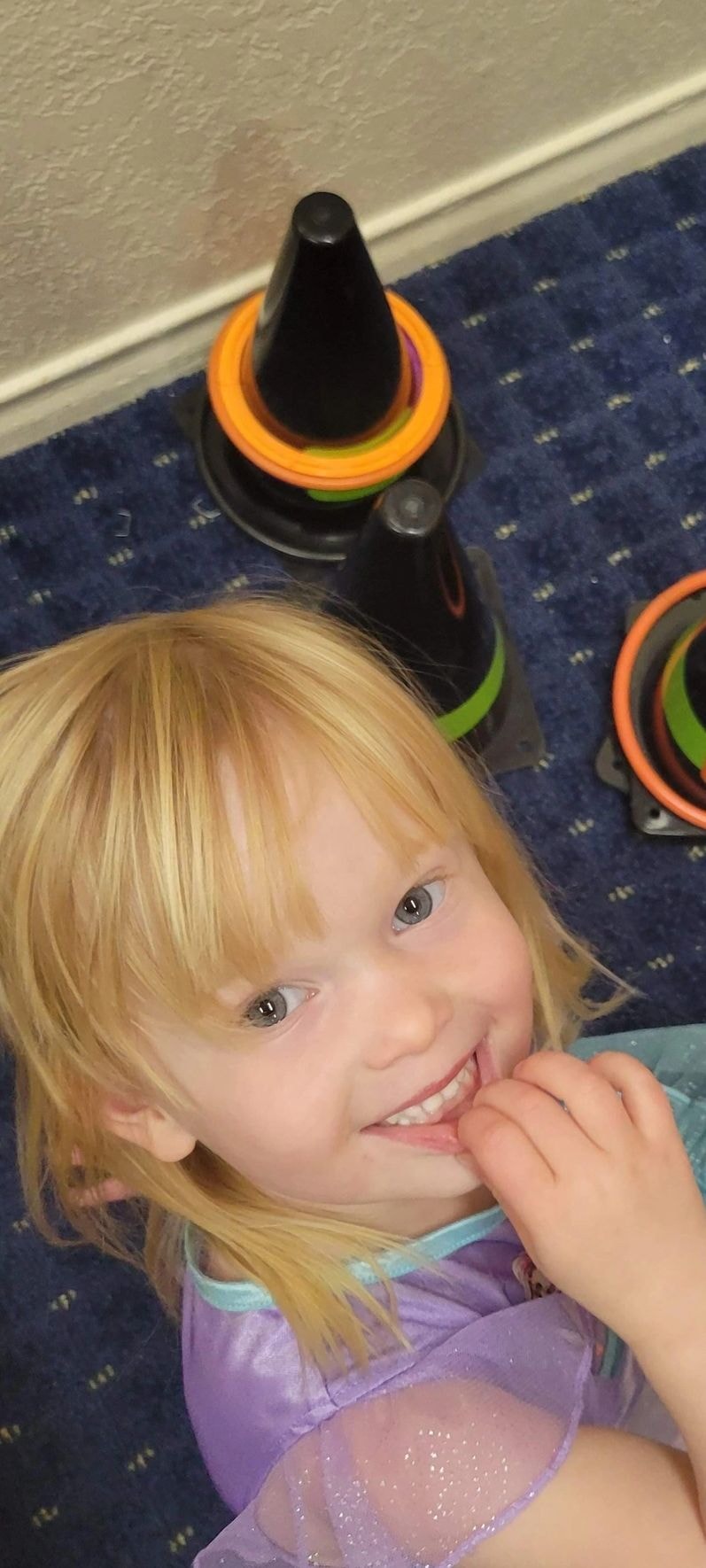 Child wearing colorful glow stick bracelets smiling