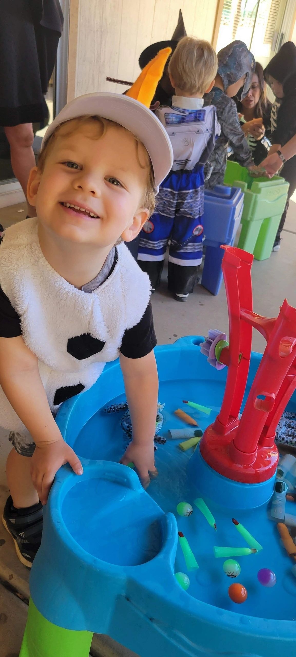 Child in costume playing at Halloween party