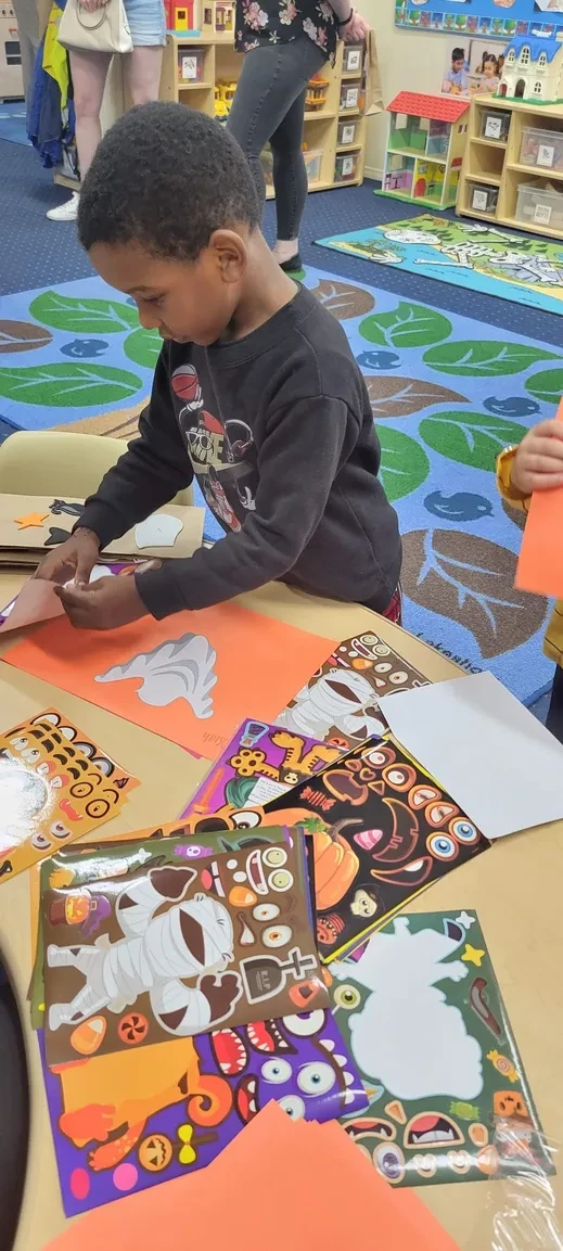 Child doing Halloween sticker craft activity