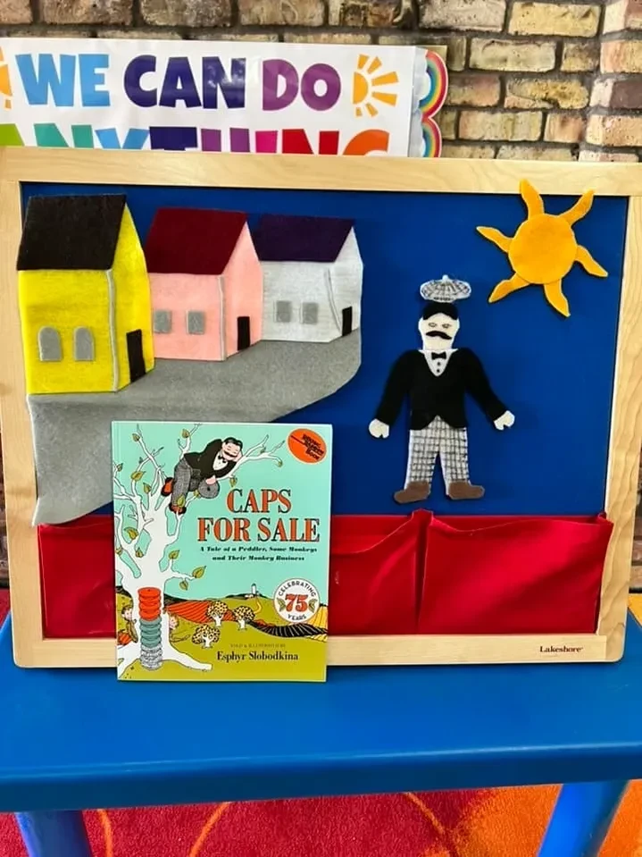 Classroom felt board display with Caps for Sale book