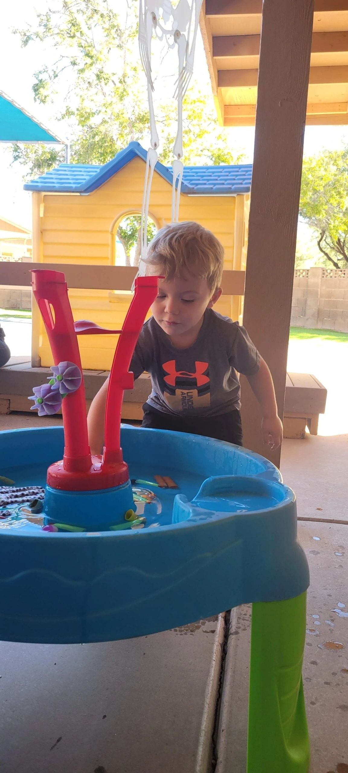 Child playing at outdoor water table